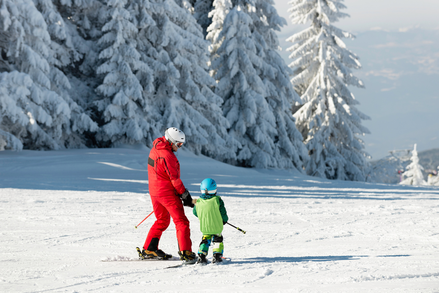 Skiing instructor and child on ski slope