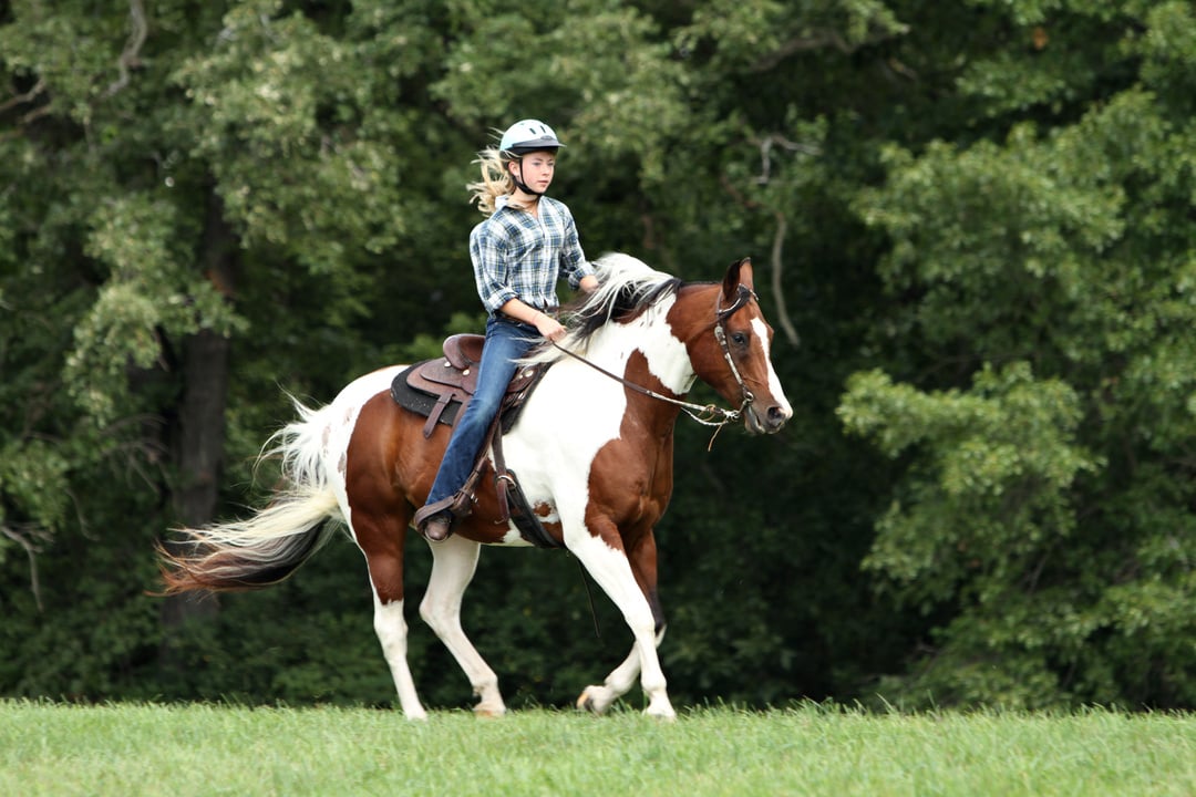 Teen riding horse