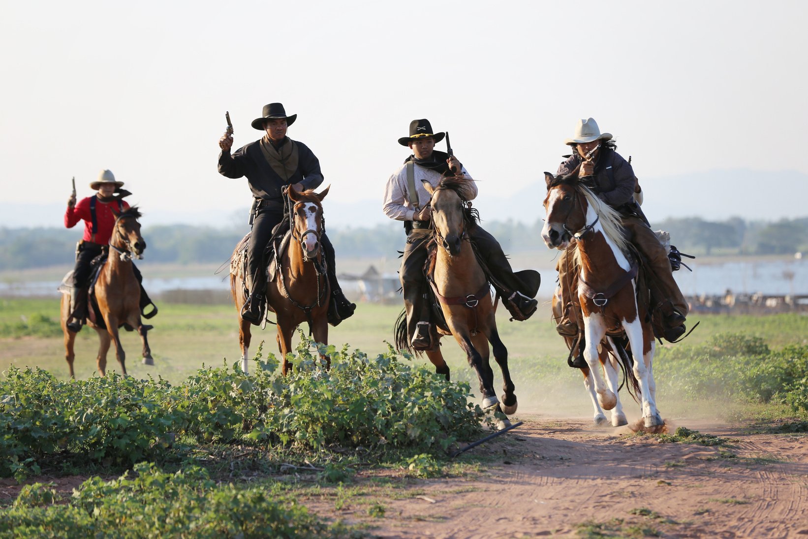 Cowboys with Guns Riding Horses 